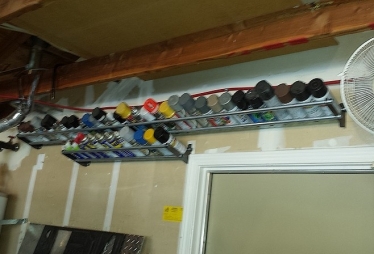 Homemade spray cans storage rack constructed from steel plate and pipe