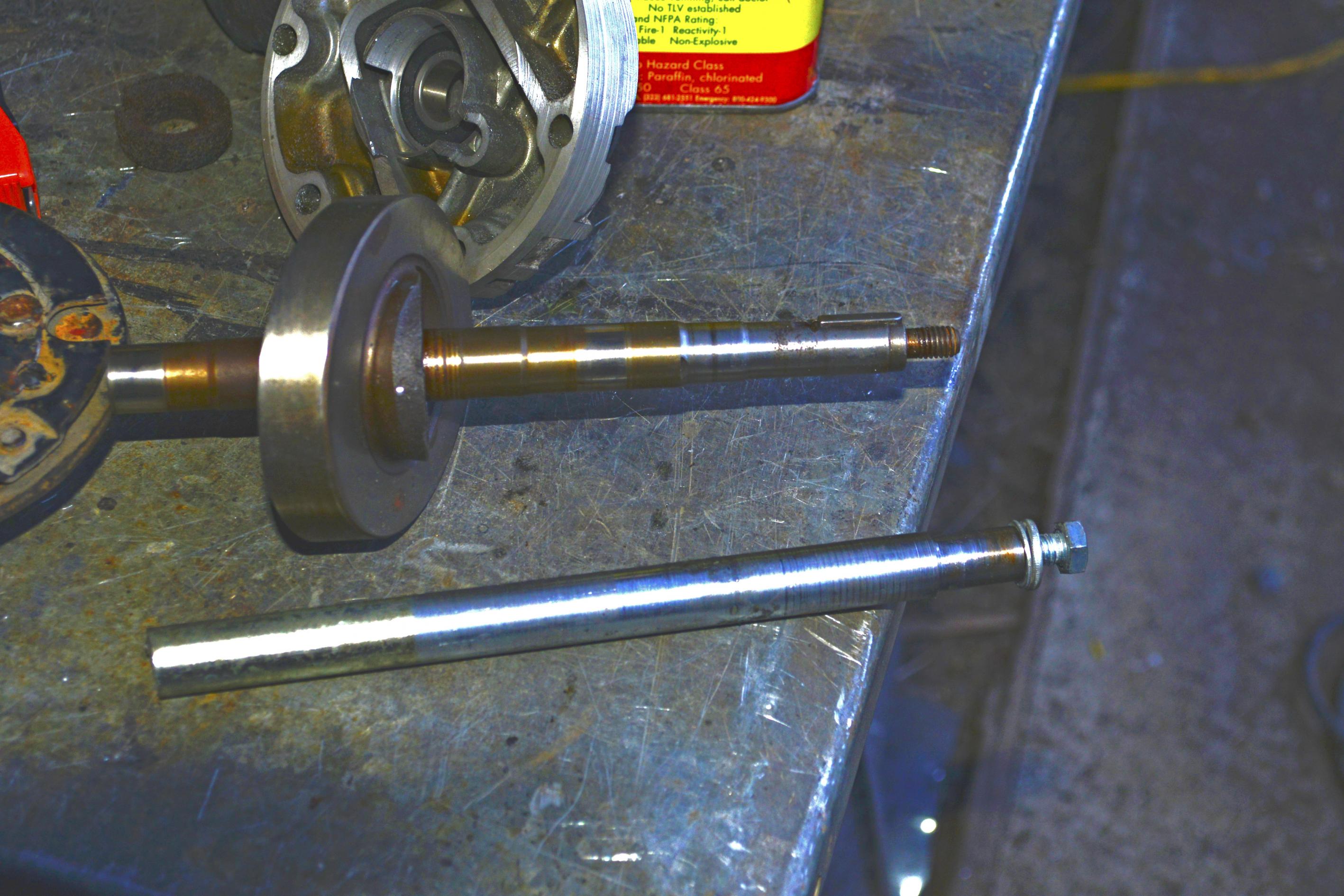 DSC5735 copy Was originally going to reuse the old crank shaft but decided to build anew.  This compressor's shaft has a straight-cut and key-way for the outer plate -- many of the smaller cars I understand have a tapered shaft so making a new one was very easy.  Turned end down to fit pulley then cut a key-way.  The old one was externally threaded for a 5/16 nuts...I just reversed that the drilled and tapped a 5/16 hole there was enough meat that the key-way would cut into the tapped hole